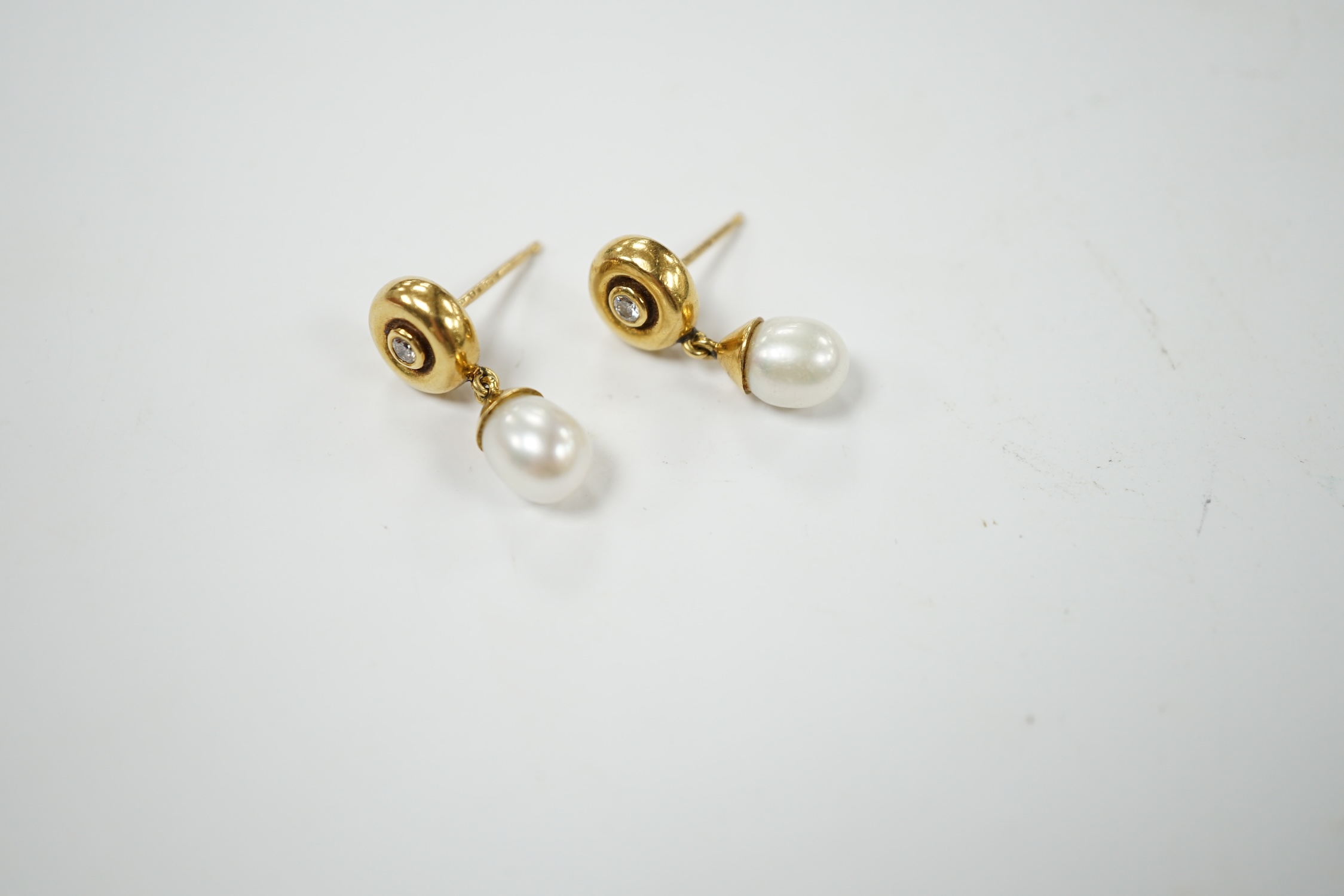 A modern pair of Boodles & Dunthorne 18ct gold, single stone cultured pearl and single stone diamond set drop earrings, lacking butterflies, 21mm, gross weight 5.1 grams. Condition - fair